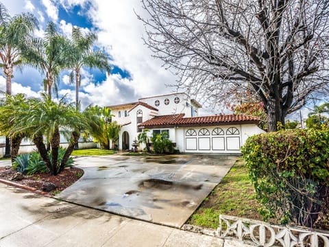 Spanish style, circular drive way easy in/out, 2 car garage & corner lot.