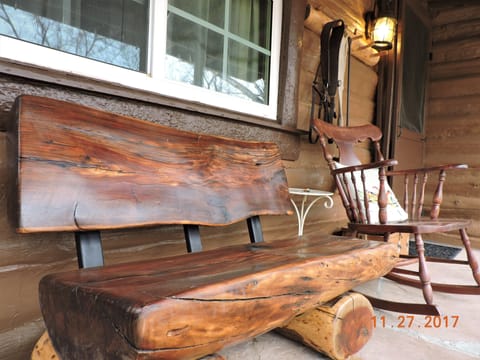 Cabin Front Porch: Dave finished this Log Bench he bought at an Artist's sale!