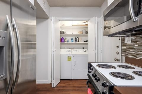 Full size washer and dryer located off kitchen area