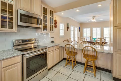 The dining table has seating for 8 and there are 6 chairs at the breakfast bar.