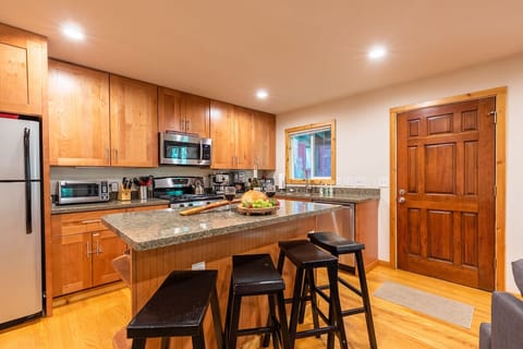 Fully stocked kitchen with an island for food prep or breakfast
