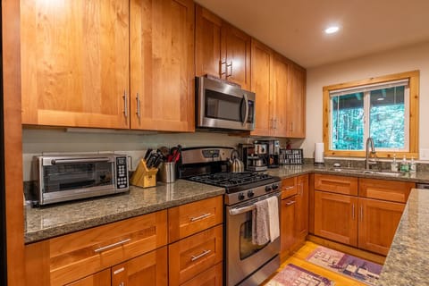 Well appointed kitchen with warm wood and cool granite