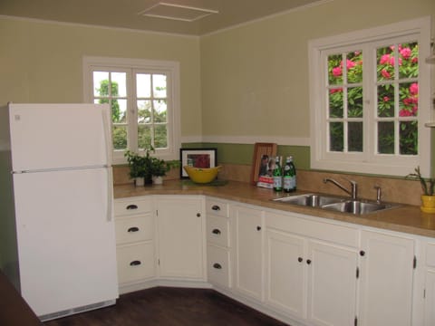 The kitchen is filled with light and views of beautiful foliage.