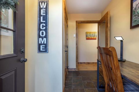 Office area with a spacious desk, comfortable seating, and ample lighting—perfect for remote work or study. Designed for productivity and convenience.