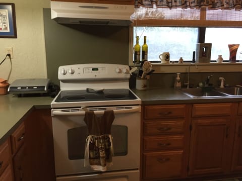 Full size stove in kitchen. Utensils,pots, dishes, etc. available