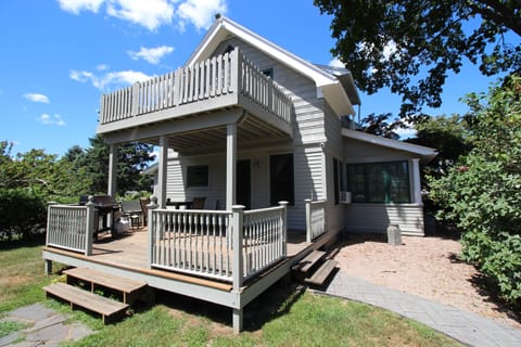 Cottage has two decks and a long private backyard extending to the dock and cove