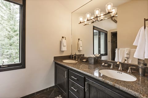 Double sinks in the upstairs master bath, large slate shower and sep toilet room