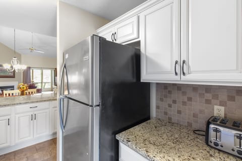 Electric dishwasher, stove, microwave, full-size refrigerator, & all dishes.