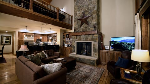 Living room with the kitchen in the background.