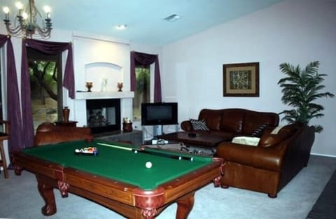 Living room w/2 santa fe leather couches & leather cognac chair & pool table.