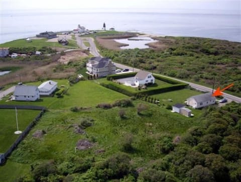 Aerial view of home.  White building with grey roof is the guest cottage.