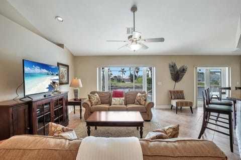 Spacious living room looking out on the water. Feel the ocean breeze!