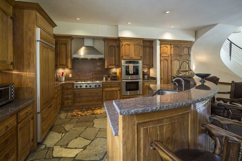 Gourmet kitchen with stainless steel Thermador and KitchenAid appliances