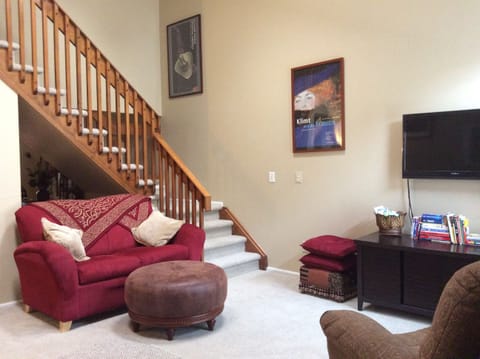 Living room + stairway to bedroom/work area upstairs