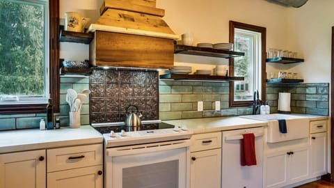 New kitchen boasts a farm sink, double ovens, reclaimed wood shelving.  All you need for host your large group including big stock pots and many dishes!