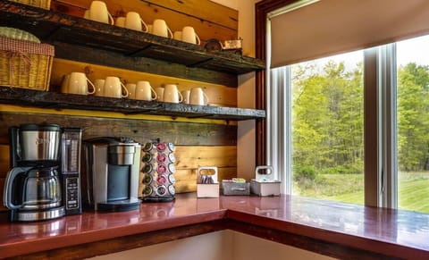 Coffee Bar overlooking the backyard, fire pit with views of the pond. +30 K-cups and traditional ground for coffee pot provided, along with tea, sweeteners and creamers. 