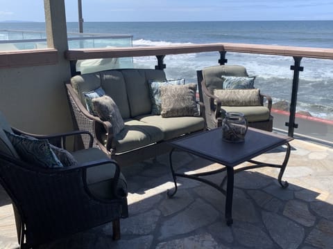 Outdoor patio furniture on ocean front balcony.