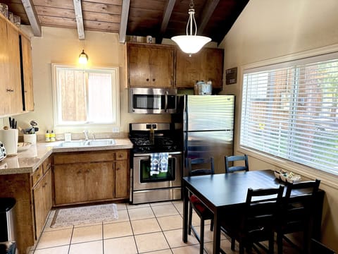 Full size refrigerator, gas stove top, microwave, and countertop toaster oven