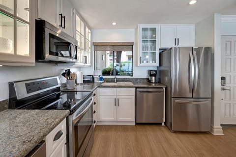 Kitchen with Refrigerator, ice maker,
dishwasher, stove, oven, coffee makers 
