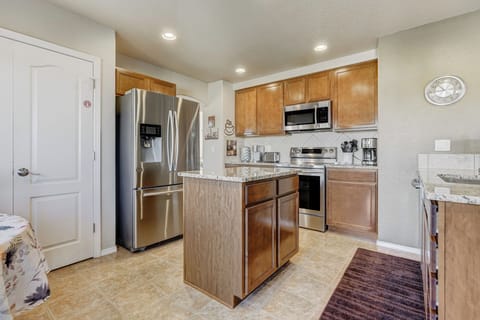 The modern Kitchen boasts granite countertops, abundance of cookware & utensils.