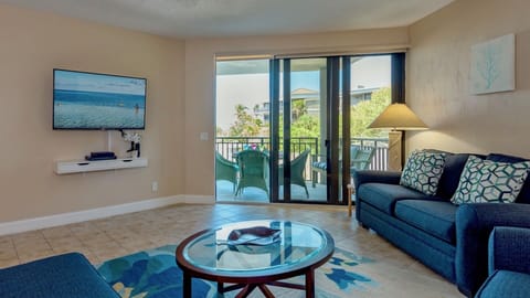 The living room has a large flat screen Smart TV and balcony access...