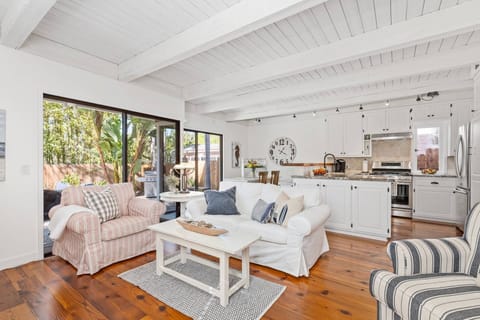 Living room with comfortable seating, kitchen and dining area