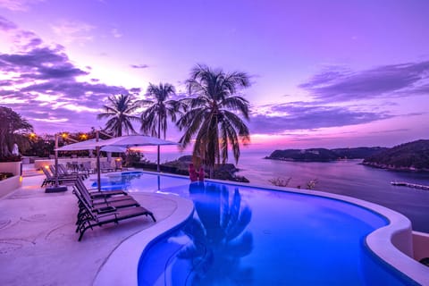 An infinity pool, sun loungers