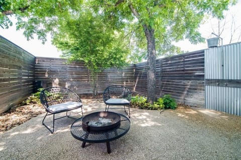 Courtyard fire pit – gather under the trees with outdoor seating.