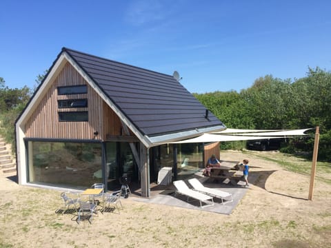 Sun-drenched spacious location amidst the sandy dunes by the seaside.