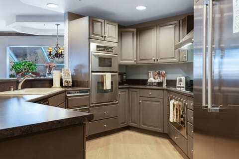 Fully Stocked Kitchen with Large Sub Zero Refrigerator, Double Ovens, Electric Cook Top, Microwave and Dishwasher.