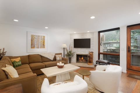 This condo features a gas fireplace, flat screen tv, and balcony with views of the Little Nell ski run on Aspen Mountain.