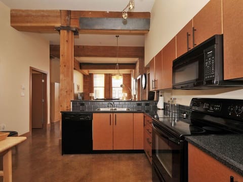 Spacious kitchen with modern appliances and rustic charm