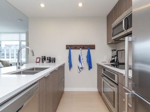 Sleek modern kitchen with stainless steel appliances and bright counters