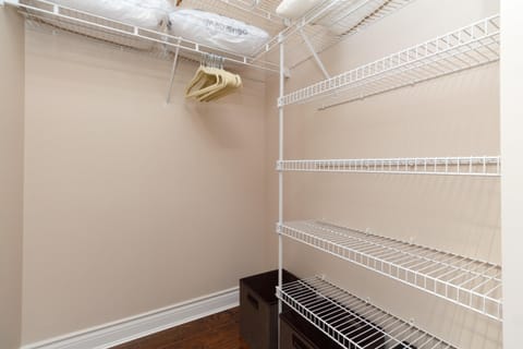 Spacious walk-in closet with ample shelving and storage