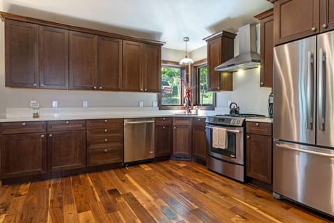 Spacious fully equipped kitchen with stainless steel appliances.
