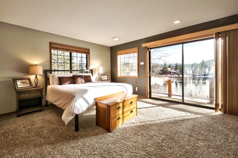 Giant master suite is upstairs, with king bed, stunning views of the back yard and waterway below, and cozy sitting area with gas fireplace