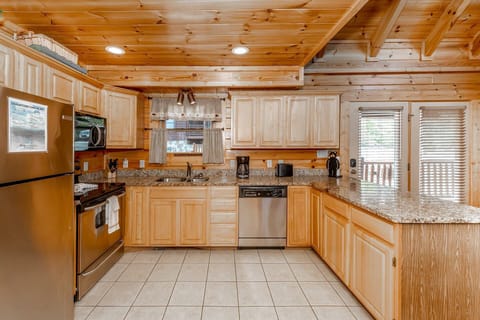The updated kitchen featuring granite countertops, stainless steel appliances and stocked with your basic essentials for dinner at home.