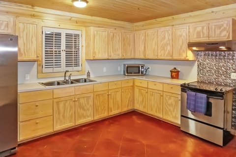 Large kitchen with stove, oven, refrigerator, microwave, and coffee maker