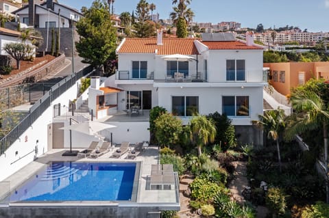 A heated pool, sun loungers