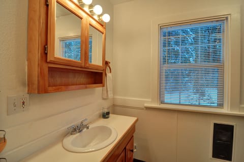 Bathroom - This bathroom located downstairs has a bathtub shower and toilet.