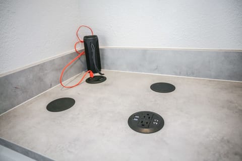 Charging station with USB docks and built-in phone charging pads