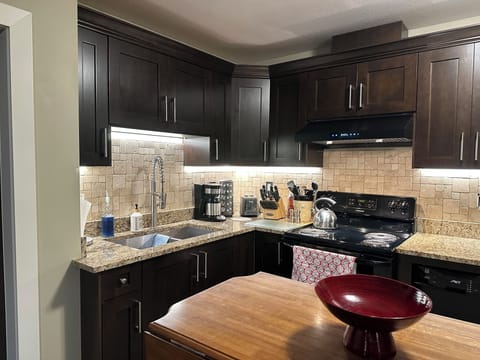 New travertine backsplash and counter lighting