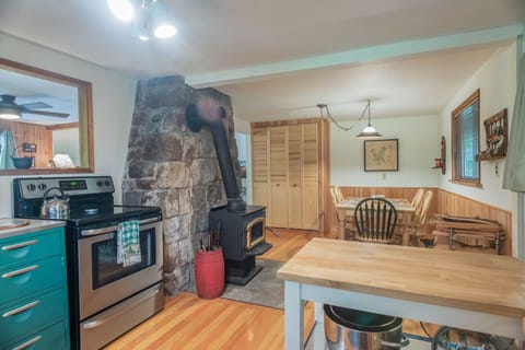 Kitchen - In the kitchen there is a wonderful wood burning wood stove next to the oven. Refrigerator, microwave and much more! The dining room table seats 6.