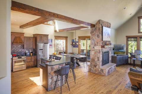 Main level great room combines the kitchen, dining & living rooms