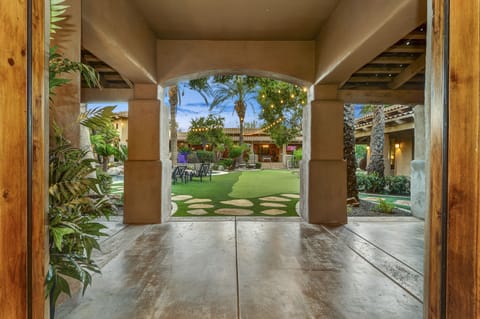 A private courtyard oasis beckons with a heated pool, spa, lush gardens, and versatile outdoor game amenities. Ideal for families and large groups, this outdoor haven boasts covered patios, a BBQ area, and a bar, ensuring a perfect blend of serenity and entertainment.