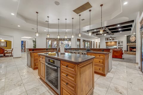 Experience culinary convenience in the kitchen equipped with double ovens, a dedicated prep area, and two sinks for efficient and enjoyable meal preparation.