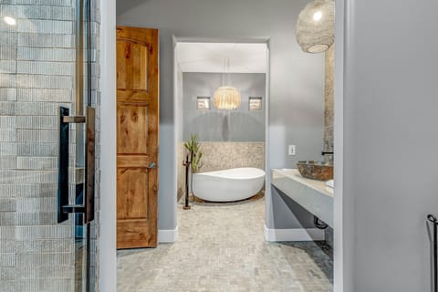 Indulge in luxury in Bedroom 6, boasting a private bath with a fully renovated separate shower and tub room, featuring all-new tile and fixtures in the 2023 upgrade.