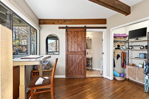 Dedicated workstation and closet with yoga mats/accessories.