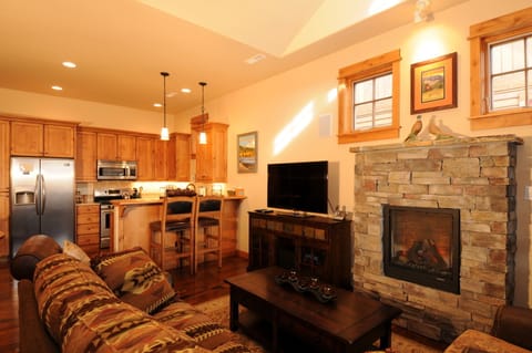 The living room features a cozy fireplace and flat-screen TV.