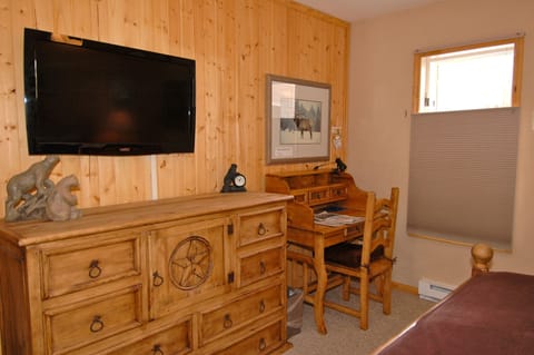 Viking Lodge 311 - the bedroom has a desk & a flat screen TV.